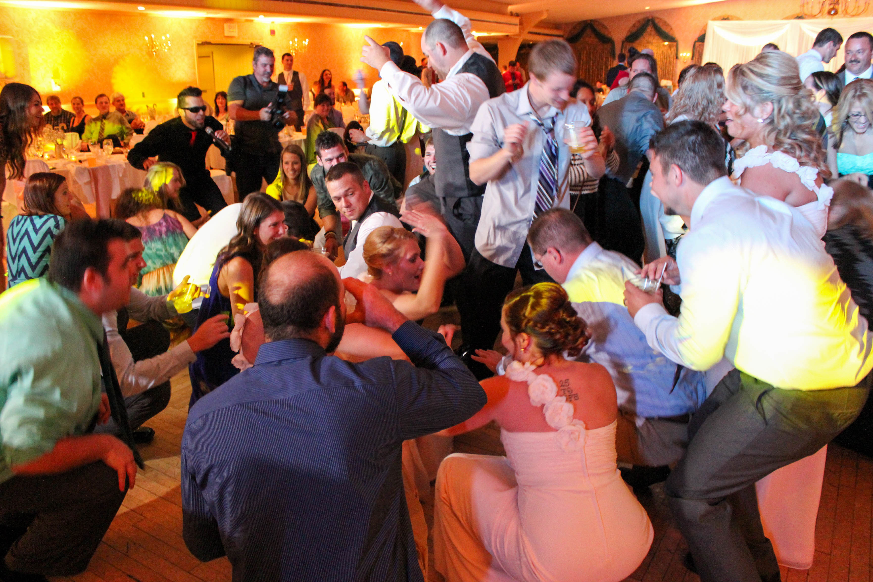 DJ Kyle Mac performing at wedding reception with packed dance floor